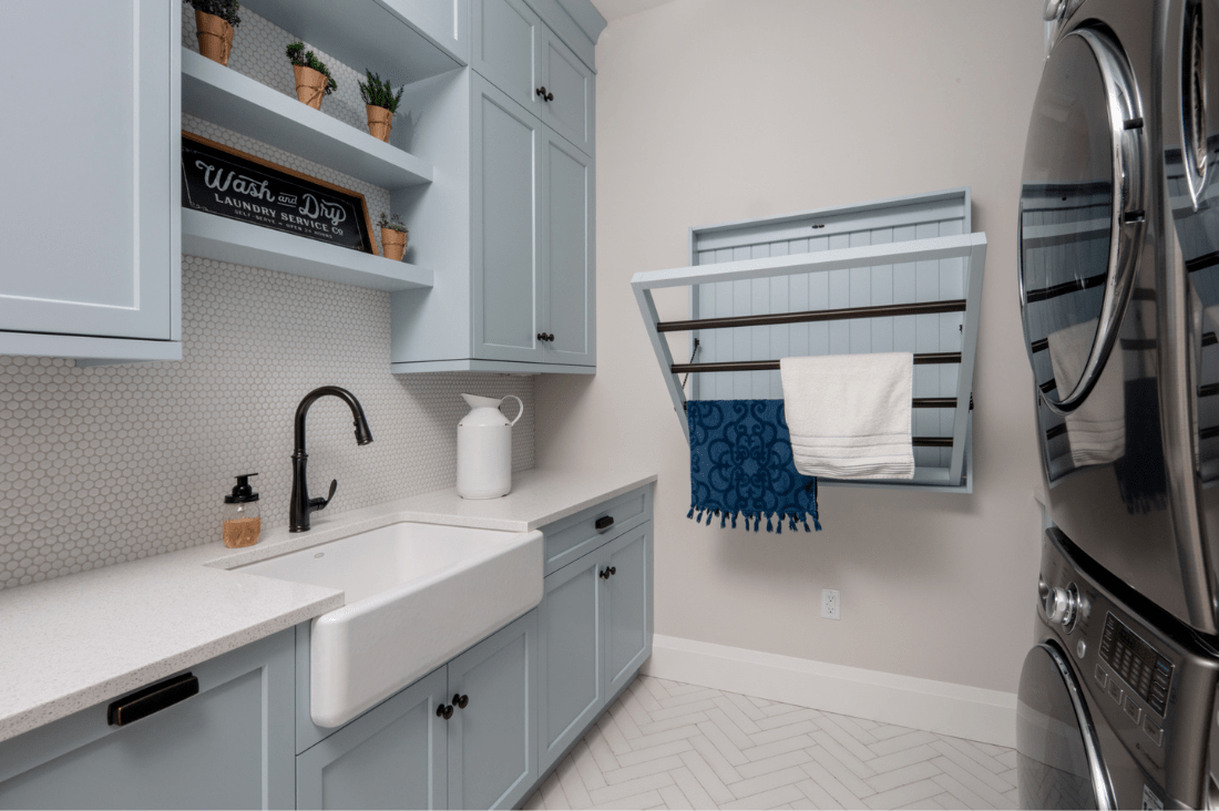Custom laundry room with light blue cabinetry