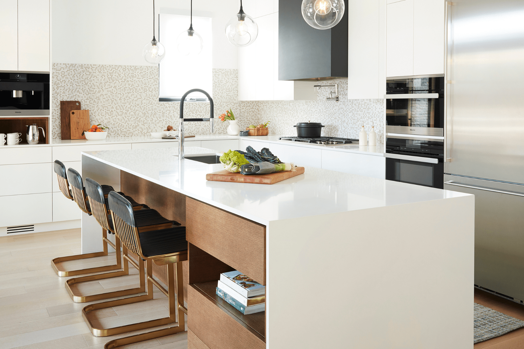 Bright modern chicken with white waterfall countertop and black accents