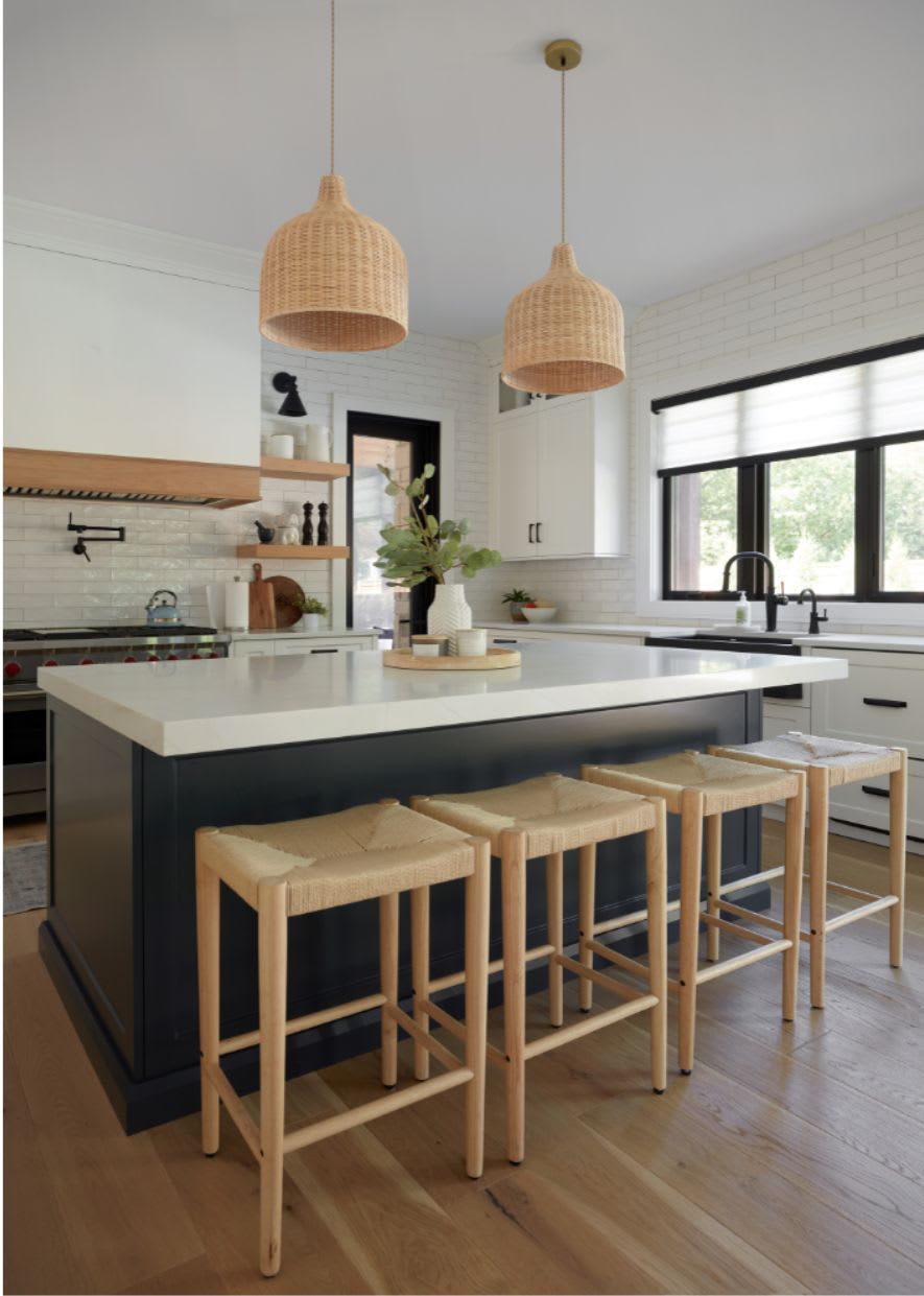 white modern kitchen with dark island and boho accents