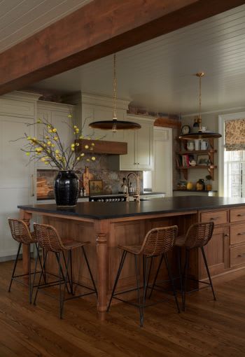 Farmhouse kitchen with wood island and stone backsplash