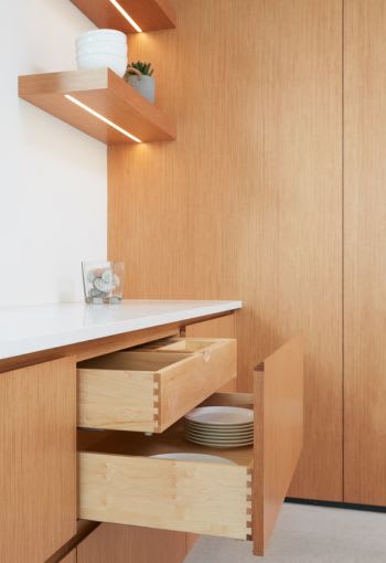 Modern oak kitchen with light under floating shelves