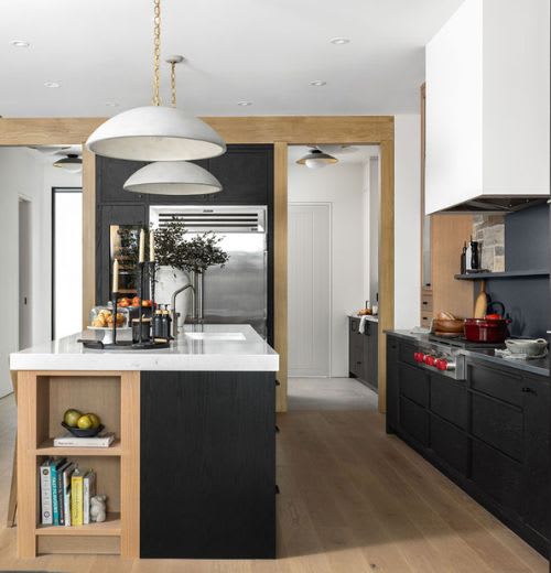 Modern kitchen layout with kitchen island featuring an exposed bookshelf