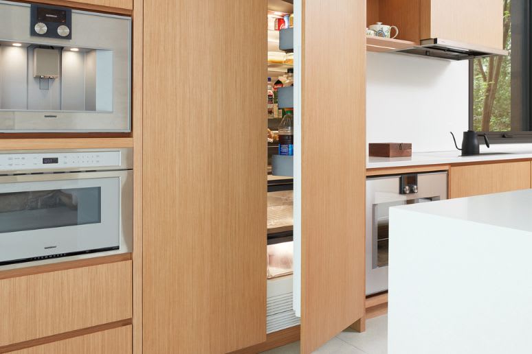 Built in hidden fridge in custom kitchen cabinets