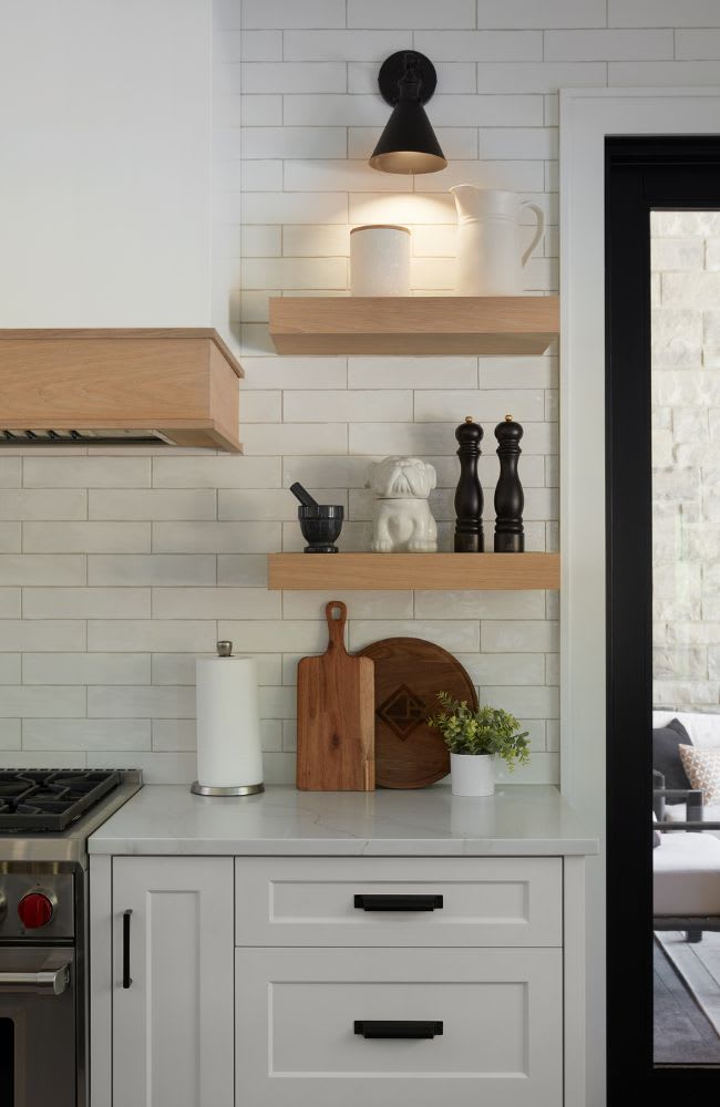 Custom kitchen  with floating wooden display shelves on wall