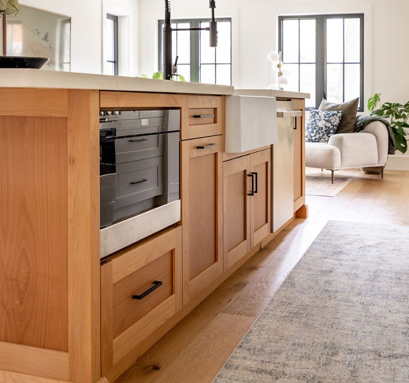 Close up of oak kitchen island with black hardware