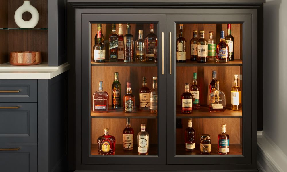 Close up of custom whiskey bar with glass panel doors