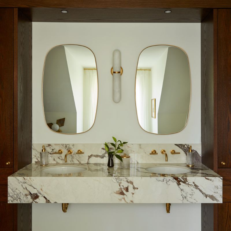 Modern bathroom with oak cabinets and double marble vanity