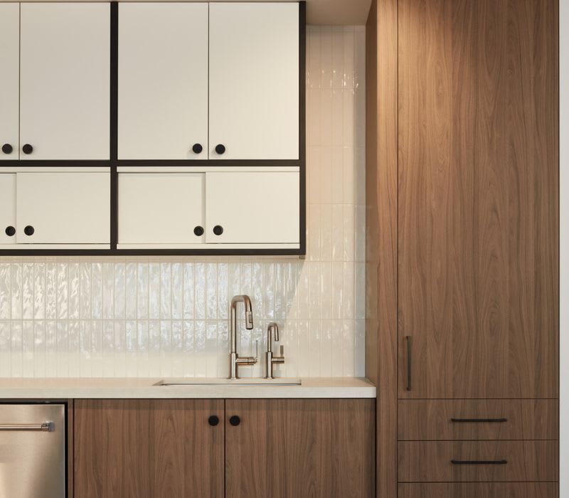 Custom walnut and white cabinets in office lunchroom